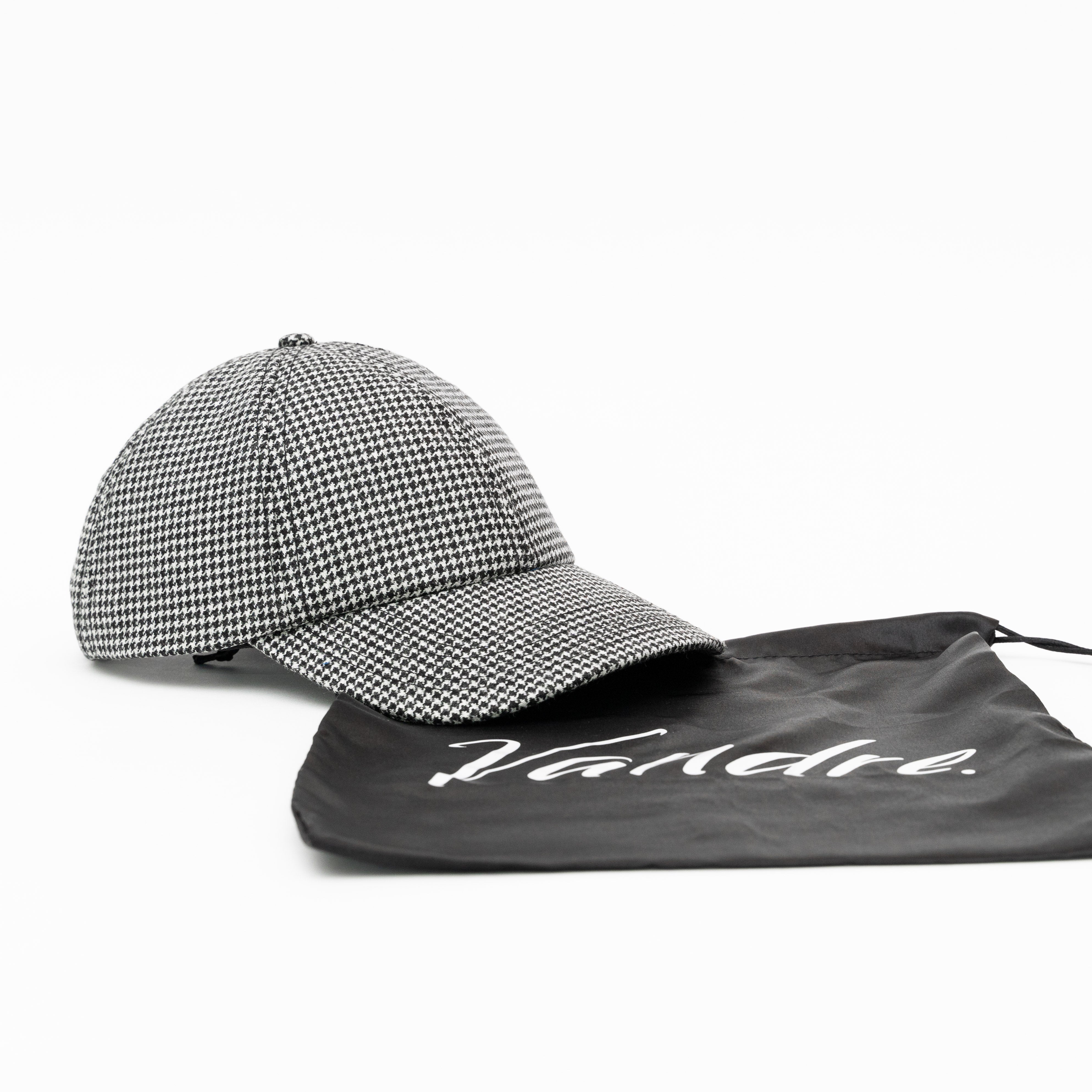 Vandre 100% wool houndstooth baseball hat with the custom satin storage bag.